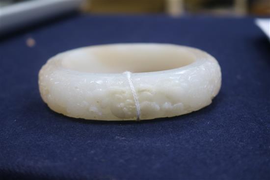 A Chinese white and russet jade bangle